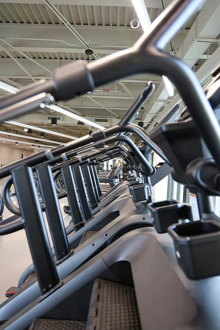 Looking through the handlebars at a row of treadmills